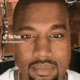 a close up of a man 's face with a beard and a tiktok watermark .