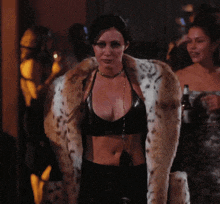 a woman wearing a leopard print fur coat and a black top