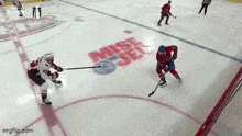 a hockey game is being played on a rink that has the word miss on it