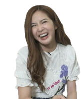 a woman wearing a white shirt with a purple flower on it is laughing .