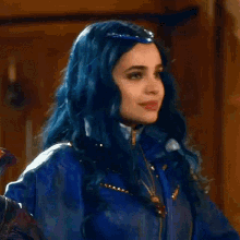 a close up of a woman with blue hair wearing a blue jacket and necklace .
