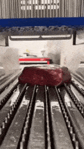a large piece of meat is being cooked on a grill in a machine .