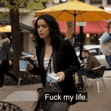 a woman walking down the street with the words " fuck my life " on the bottom right