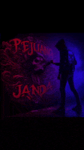 a man in a hoodie stands in front of a wall that says pejuang jada