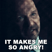 a man in a suit and tie is saying " it makes me so angry "