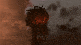 a large sphere with a face on it is in the sky above a building