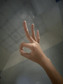 a person 's hand is making an ok sign