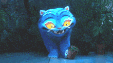 a blue cat with yellow eyes is standing on a sidewalk in the dark