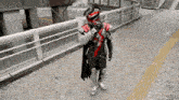 a man in a superhero costume stands on a sidewalk