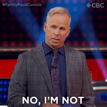 a man in a suit and tie is saying " no i 'm not "