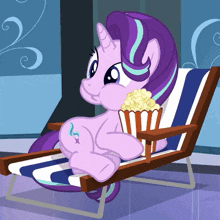 a cartoon pony is sitting in a chair with a bowl of popcorn