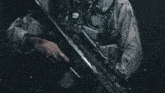a close up of a person holding a sniper rifle with a scope that says eotech