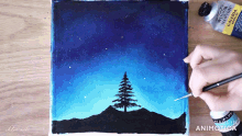a person is painting a tree in the night sky with a bottle of winsor newton acrylic paint