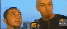 two men are standing next to each other with a mtv logo in the background