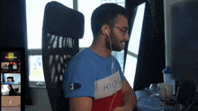 a man wearing headphones and a shirt that says hilfig