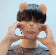 a young man wearing a teddy bear mask makes a face