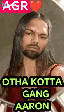 a man with long hair and a beard looks at himself in the mirror .