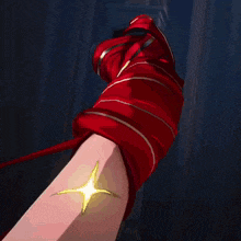 a close up of a person 's arm with a red glove on it