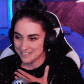 a woman wearing headphones and horns is smiling