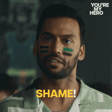 a man with paint on his face says shame