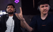 two men wearing headphones and a shirt that says supreme on it