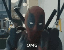 deadpool is wearing a mask and holding two swords in his hands .