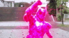 a person in a pink costume is standing on a sidewalk .