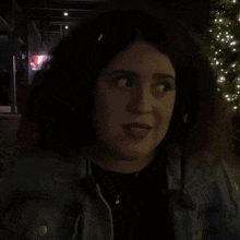 a woman in a dark room with the word ok above her head