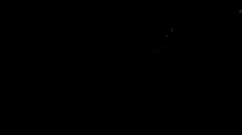 a man singing into a microphone in a dark room