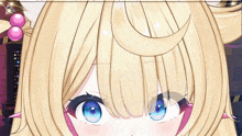 a close up of a girl 's face with blue eyes