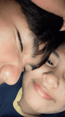 a close up of a man and woman 's faces with their eyes closed