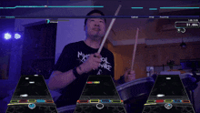 a man in a my chemical romance shirt plays drums