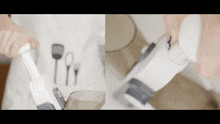 a person is using a vacuum cleaner with utensils in the background