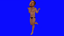a man in underwear is jumping in the air on a blue screen