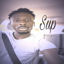 a man in a car with the word sup written on the back