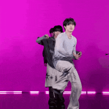 a group of people are dancing in front of a purple background .