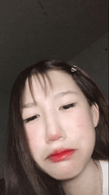 a close up of a woman making a funny face with her eyes closed