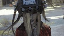 a woman with long blonde hair is wearing a helmet and a red jacket .