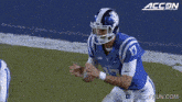 duke football player number 17 throws the ball