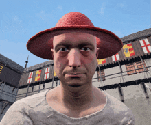 a man wearing a red hat stands in front of a castle