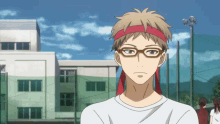 a young man wearing glasses and a red headband stands in front of a building