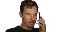 a man in a black shirt is looking at a cell phone with his eyes closed