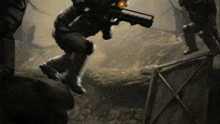 a man with a gun is jumping over a box
