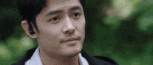 a close up of a man 's face with his eyes closed