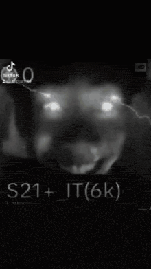 a black and white photo of a person 's face with lightning bolts coming out of his eyes .