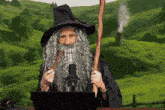 a man in a wizard costume is smoking a pipe in front of a laptop