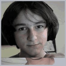 a young man wearing headphones is looking at the camera