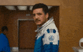 a man in a blue and white space suit with the number 4 on the shoulder