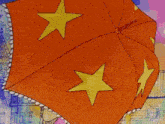 a red umbrella with a yellow star on it and the words label on the bottom