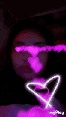 a girl with a unicorn horn and hearts behind her